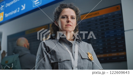 Portrait of Security Officer in Airport Terminal: Female TSA Worker in Uniform Looking at Camera Portrait of Security Officer in Airport Terminal: Female TSA Worker in Uniform Looking at Camera 122609643
