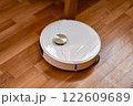 Robot vacuum cleaner cleans the apartment 122609689