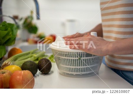 Cooking of quick fresh healthy dinner by prepare of green spinach, celery in hand plastic dryer. Cooking of quick fresh healthy dinner by prepare of green spinach, celery in hand plastic dryer. 122610807