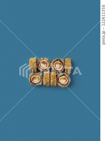 top shot on blue background lies a set of sushi with rice and seafood avocado sushi wrapped in salmon meat red caviar with seaweed professional Japanese cuisine kitchen sushi without shade top shot on blue background lies a set of sushi with rice and seafood avocado sushi wrapped in salmon meat red caviar with seaweed professional Japanese cuisine kitchen sushi without shade 122611358