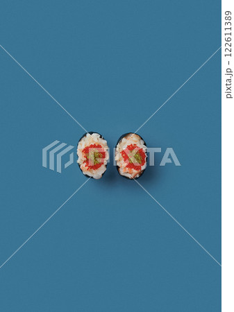 top shot on blue background lies a set of sushi with rice and seafood avocado sushi wrapped in salmon meat red caviar with seaweed professional Japanese cuisine kitchen sushi without shade top shot on blue background lies a set of sushi with rice and seafood avocado sushi wrapped in salmon meat red caviar with seaweed professional Japanese cuisine kitchen sushi without shade 122611389