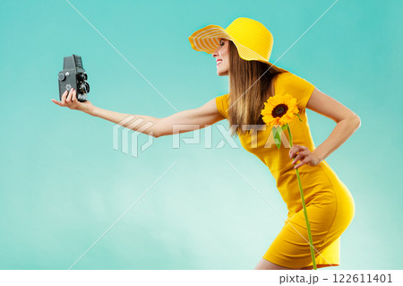 Summer woman holds sunflower old camera 122611401