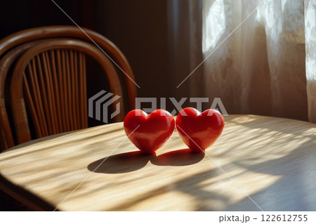 Two red hearts on table with sunlight. 122612755