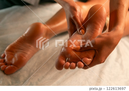Close-up of feet, woman having leg rehabilitation massage. 122613697