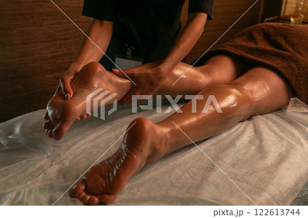 Close-up of feet, woman having leg rehabilitation massage. Close-up of feet, woman having leg rehabilitation massage. 122613744