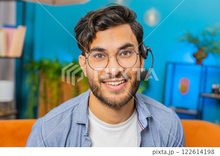 Indian man freelance worker call center, support service operator helpline having talk with client Indian man freelance worker call center, support service operator helpline having talk with client 122614198