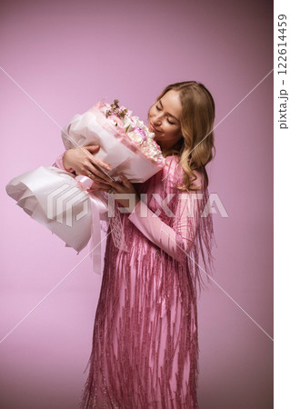 Blonde charming in a pink dress with flowers on a Blonde charming in a pink dress with flowers on a 122614459