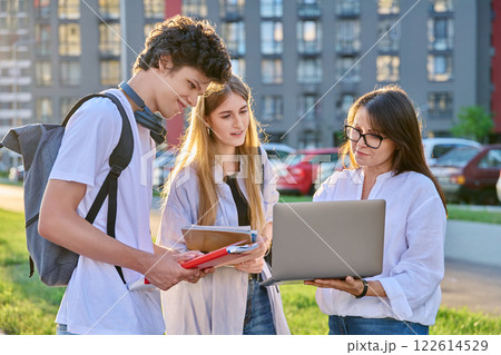 Group of college students talking with female teacher coach mentor, outdoor 122614529