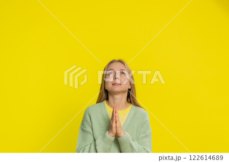 Middle-aged woman praying making wish, asking hopeful help, begging apology, meditation, imploring Middle-aged woman praying making wish, asking hopeful help, begging apology, meditation, imploring 122614689