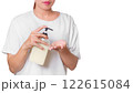 Woman in White Shirt Using Pump Bottle to Dispense Cream on Palm for Skincare Routine 122615084