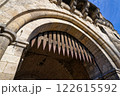 raised wooden portcullis with metal spikes at the gate castle of a medieval city fortification in cologne in sunny weather with blue sky 122615592