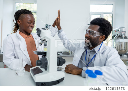 Teacher and student in lad coats looking happy and contented 122615878