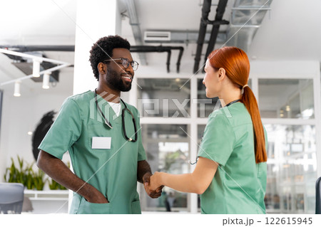 Professional doctors shaking hands at medical office meeting 122615945