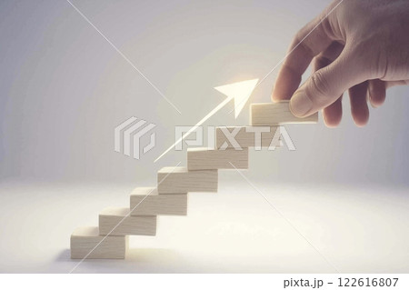 Hand Reaching for Wooden Blocks to Symbolize Career Growth and Success in Business Process 122616807