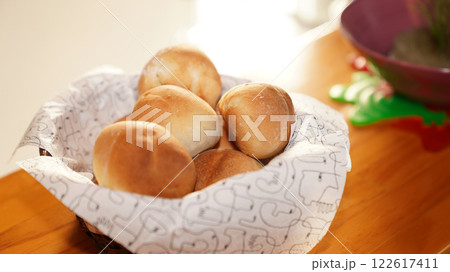 Fresh bread buns in basket on table. Breakfast buns. Fresh bread buns in basket on table. Breakfast buns. 122617411