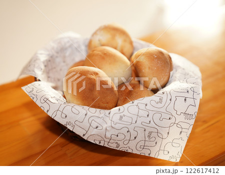 Fresh bread buns in basket on table. Breakfast buns. Fresh bread buns in basket on table. Breakfast buns. 122617412