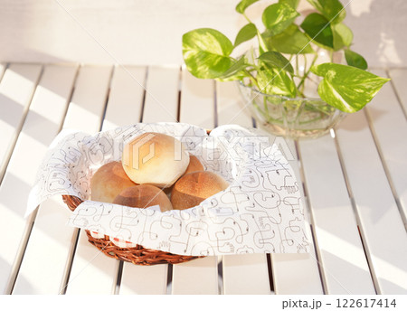 Fresh bread buns in basket on table. Breakfast buns. Fresh bread buns in basket on table. Breakfast buns. 122617414