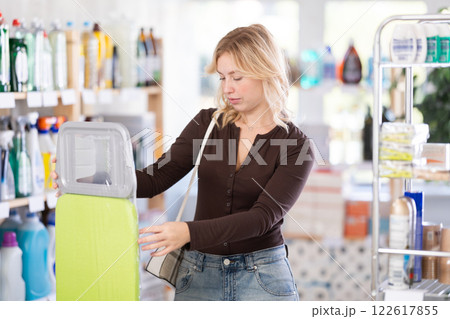 Client view product, examine details of ironing board, make sure there are no defects. Client view product, examine details of ironing board, make sure there are no defects. 122617855