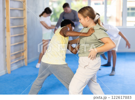 Boy and girl practicing self-defense techniques Boy and girl practicing self-defense techniques 122617883