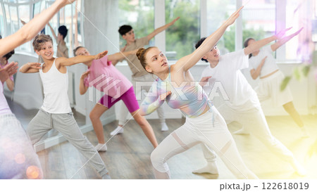 Teenagers in dance hall learn new moves. Contemporary street dance and hip-hop lesson in dance studio 122618019