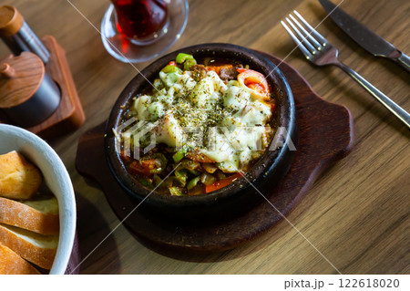 Turkish saute of meat and vegetable with melted cheese and herbs 122618020