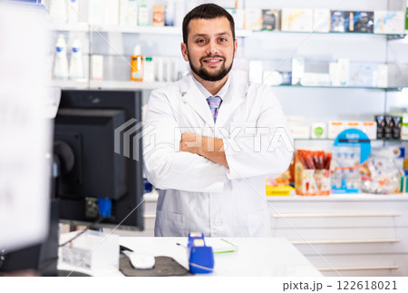 Portrait of male pharmacist working at the cash register in pharmacy Portrait of male pharmacist working at the cash register in pharmacy 122618021