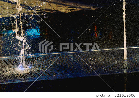 Cool water fountains flow in the heat.Hot summer 122618606