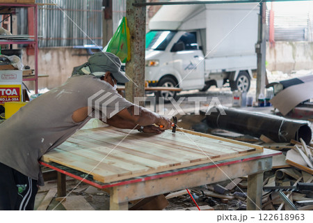 Carpenter build furniture at wood factory for sale 122618963