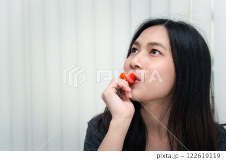 Woman eat strawberry red berry fruit sweet juicy 122619119