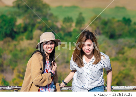 Women relax at landscape viewpoint on mountain 122619125
