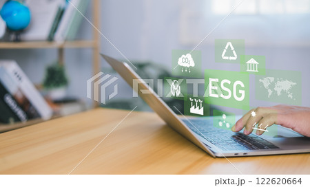 ESG environmental social governance investment business concept, Environmental and business growth together, Human hand using laptop to analyze ESG on screen in business investment strategy concept. 122620664