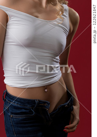 Sexy blonde in unbuttoned jeans and top view 122621847