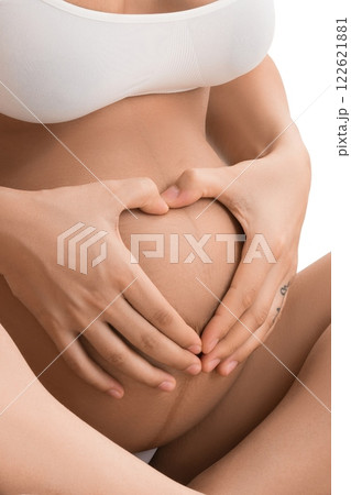 Happy pregnant woman in bed isolated shot 122621881