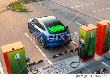 Electric auto with power indicator on rear windshield glass at public charging station 122622346