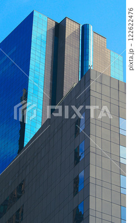 Modern Architectural Symmetry. A sleek composition of geometric lines and reflective glass, embodying contemporary urban design. Ideal for branding, portfolios, or urban concepts 122622476