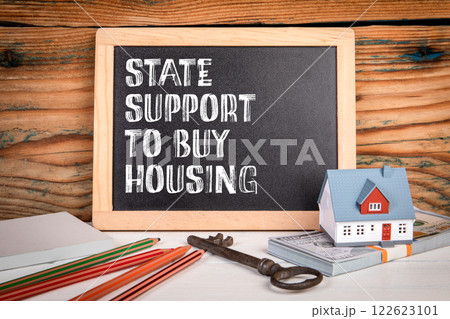 State support to buy housing. Miniature chalkboard on a wooden office desk 122623101