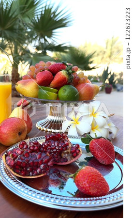 Vibrant tropical fruits displayed with pomegranate create organic masterpiece, fruits enhance natural beauty, showcasing lush greenery and organic abundance in serene tropical setting. 122623223