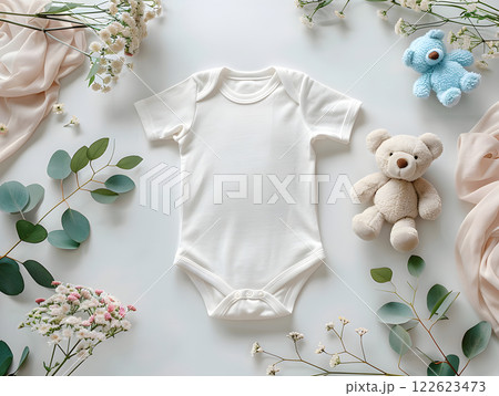 Blank white onesie mockup with baby themed decor Blank white onesie mockup with baby themed decor 122623473