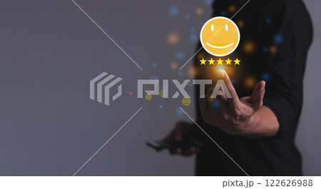 Young Man using smartphone mobile hand touching emoji five star to review and give 5 stars  122626988