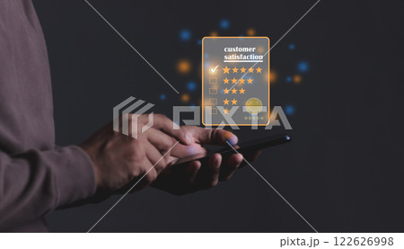 Young Man hand holding Smart Phone with five star to review and give 5 stars Young Man hand holding Smart Phone with five star to review and give 5 stars 122626998