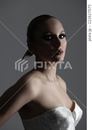 Beautiful woman dark silhouette studio portrait on gray background 122627075