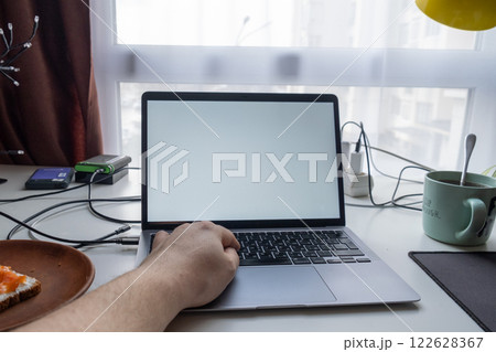 Minimalist Workspace with Laptop and Breakfast Minimalist Workspace with Laptop and Breakfast 122628367