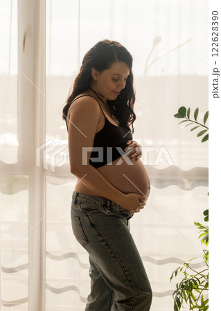 Pregnant Woman by Window in Natural Light 122628390