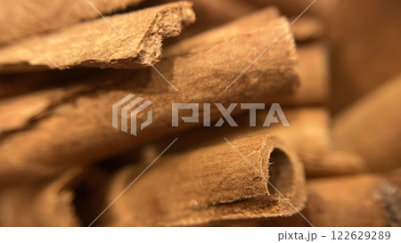 Close-up macro shot of cinnamon sticks showing rich texture and warm brown color. 122629289