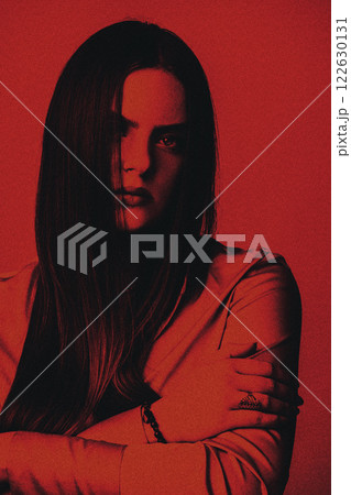 Beautiful woman with long dark hair studio portrait in red and black color style Beautiful woman with long dark hair studio portrait in red and black color style 122630131
