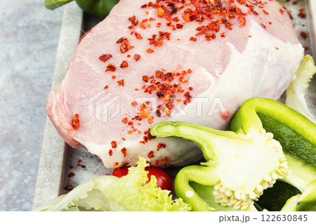 A photo of raw pork on the table. 122630845