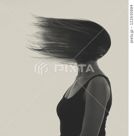 Abstract woman portrait with blowing hair on face 122630884