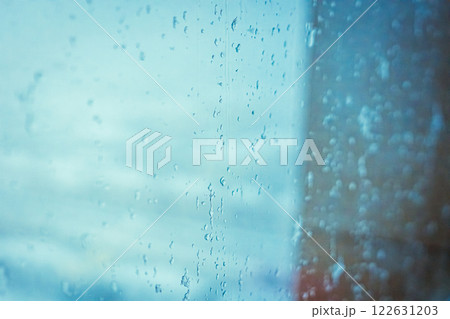 Rainy window view, Drops on glass on rainy cloudy day evoke melancholy and sadness. View of city from the window. Selective focus. High quality photo 122631203