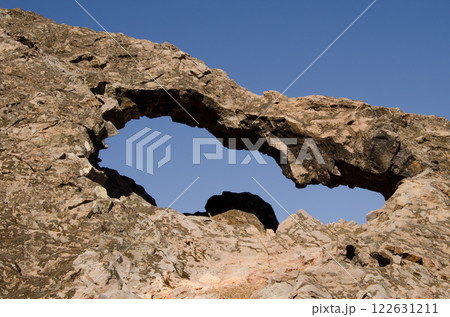 Rock forming a natural arch. Rock forming a natural arch. 122631211