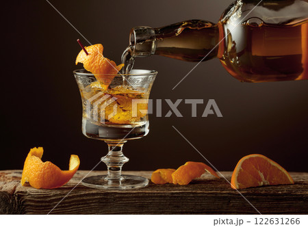 Old Fashioned cocktail with orange peel on a old wooden table. Old Fashioned cocktail with orange peel on a old wooden table. 122631266